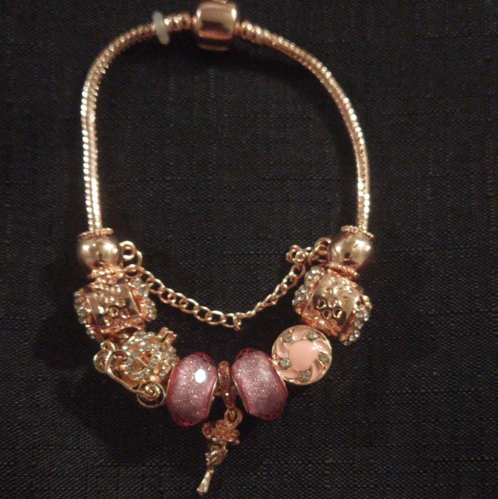 Gold and Pink Charm Bracelet with Ornate Charms. ITEM No. 19-144